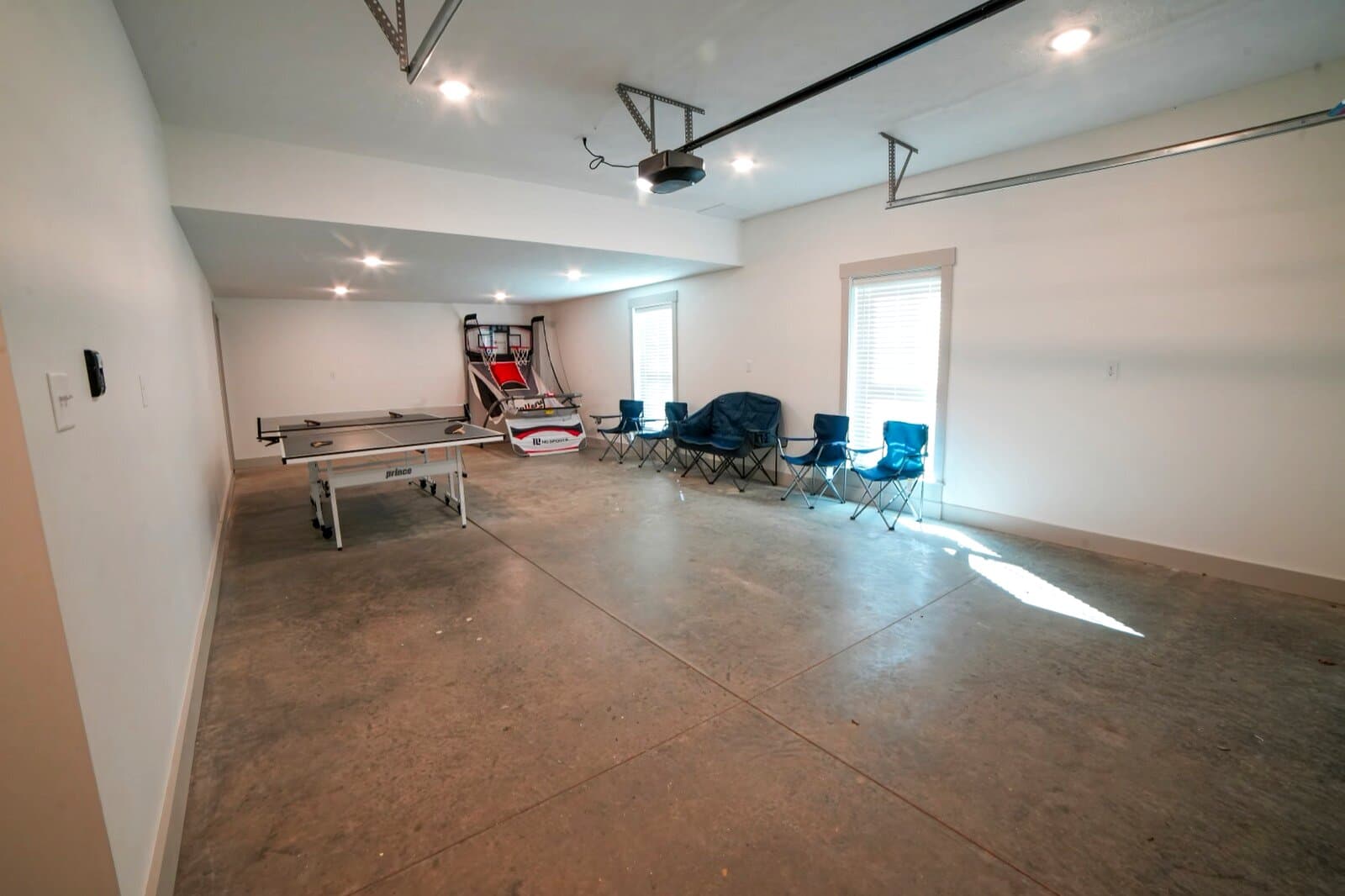 Game room — Ping pong, Pop-A-Shot, Golden Tee, cornhole storage