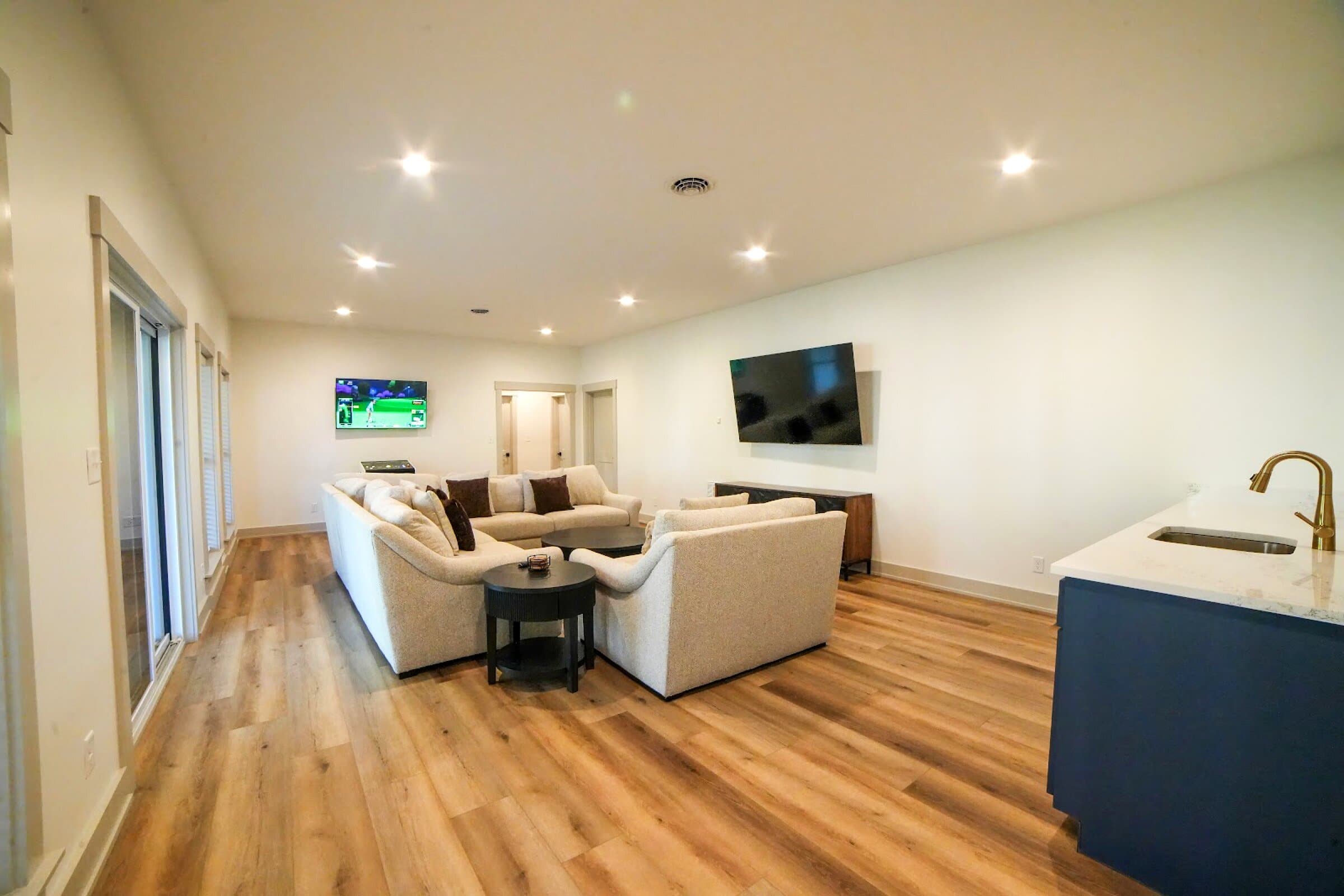 Lower living room — Second sectional, wet bar, arcade game, big TV