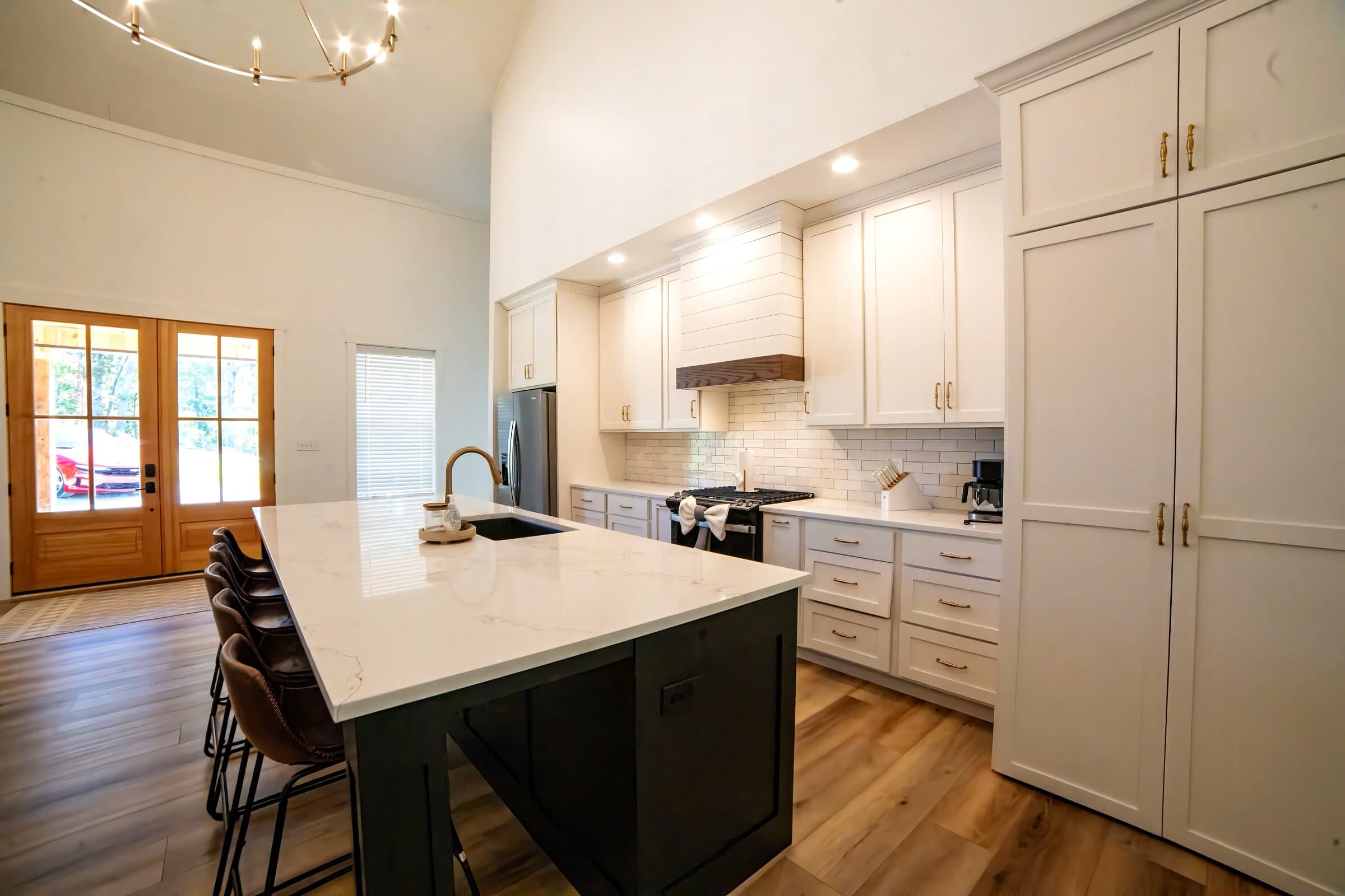 Kitchen — Calacatta marble island, gas range, brass fixtures, full pantry