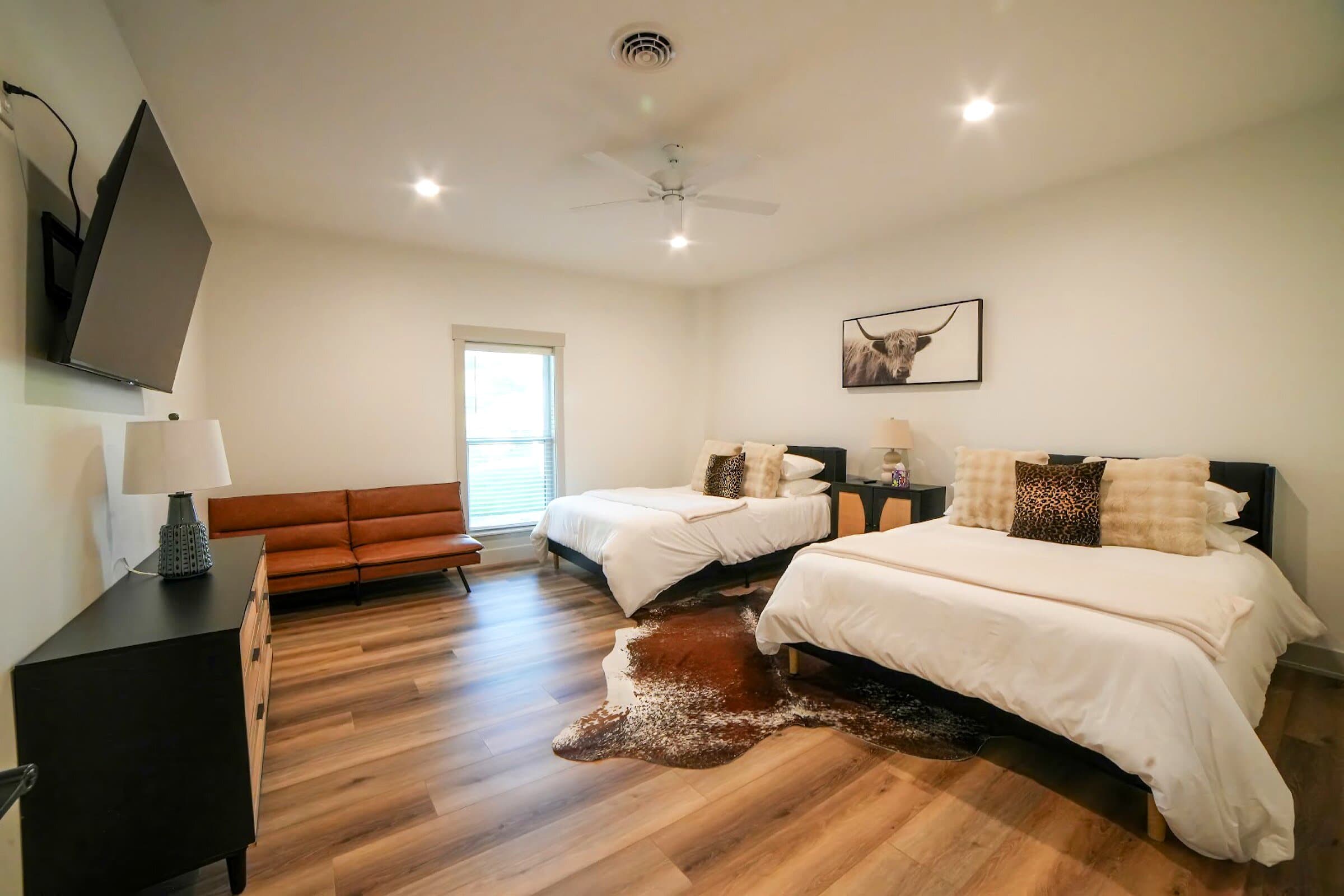 Two-queen · basement — Two queen beds, leather loveseat, TV — sleeps four