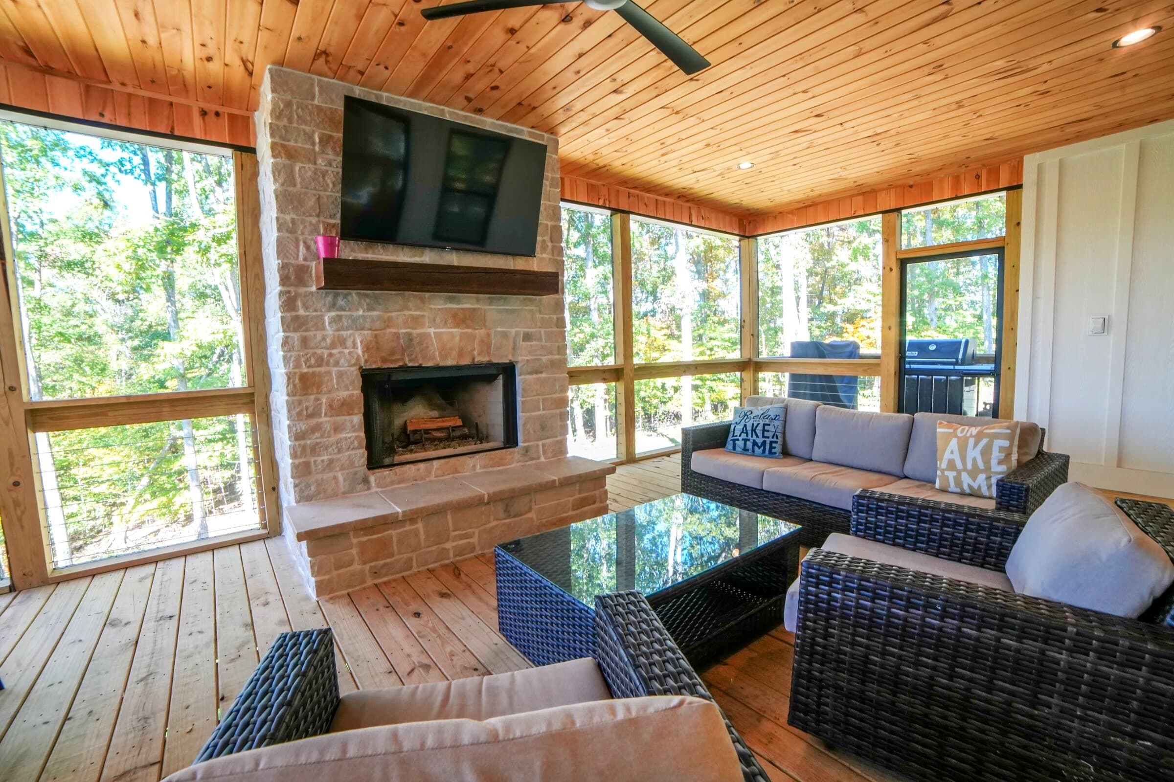 Upper screened porch — Stone fireplace, TV, dining for six, woods view — every season
